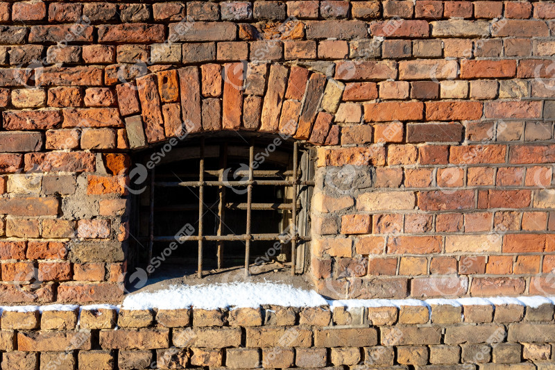 Front close-up view of a vintage brick with a window - Image