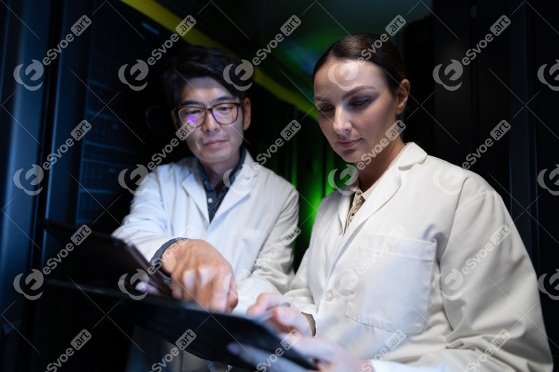 Diverse male and female engineers wearing aprons