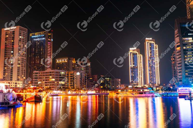 Dubai Marina canal with boats in Dubai at night