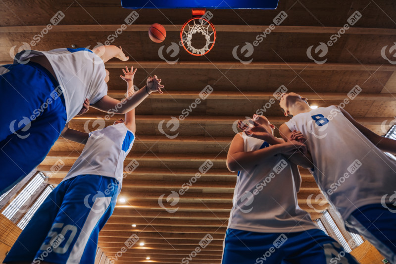 Kids in active basketball game under the hoop