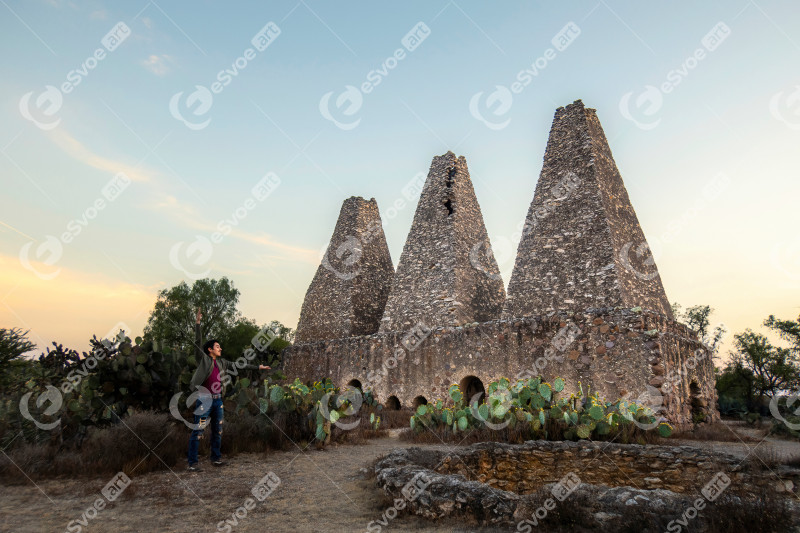 Man visiting Mine Hacienda Santa Brigida furnaces and chimneys in Mineral de Pozos, Guanajuato, Mexico