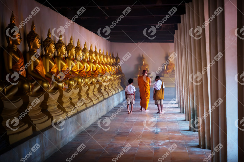 Monk and tow boy student at Golden buddha statue, Makhabucha day