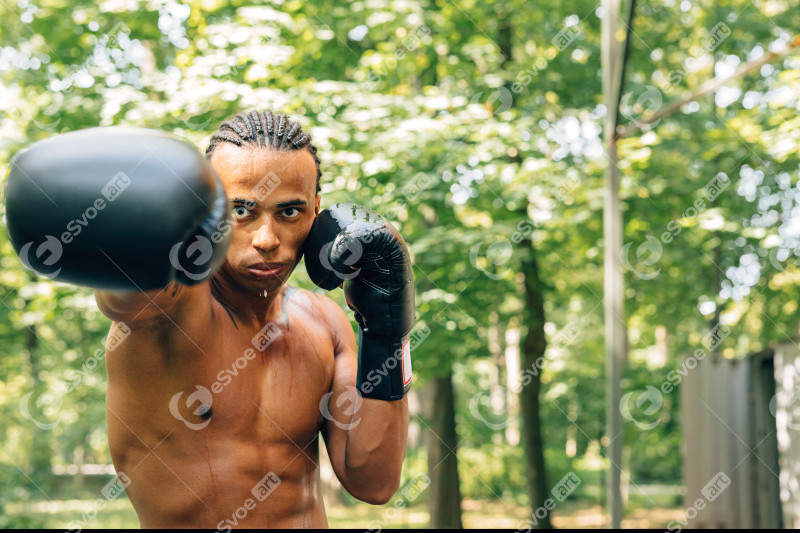 Young sweated boxer performing shadow boxing on th 2023 11 27 05 15 09 utc